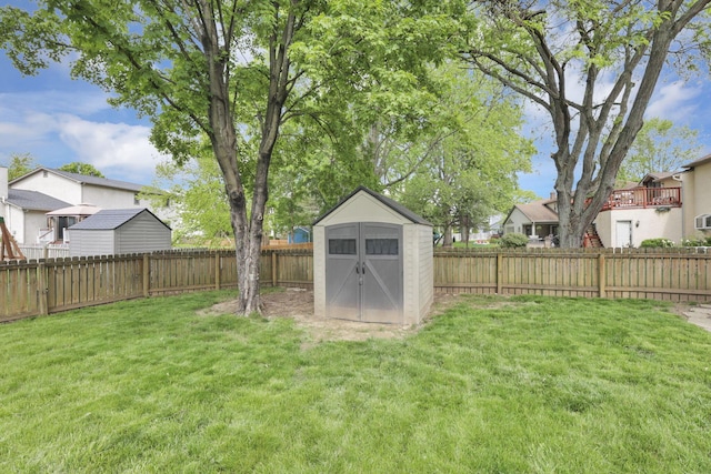 view of yard with a shed, a residential view, and an outbuilding
