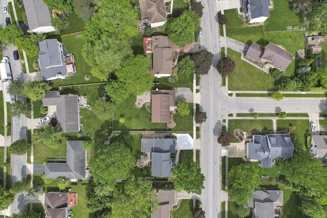 aerial view of property and surrounding area featuring nearby suburban area