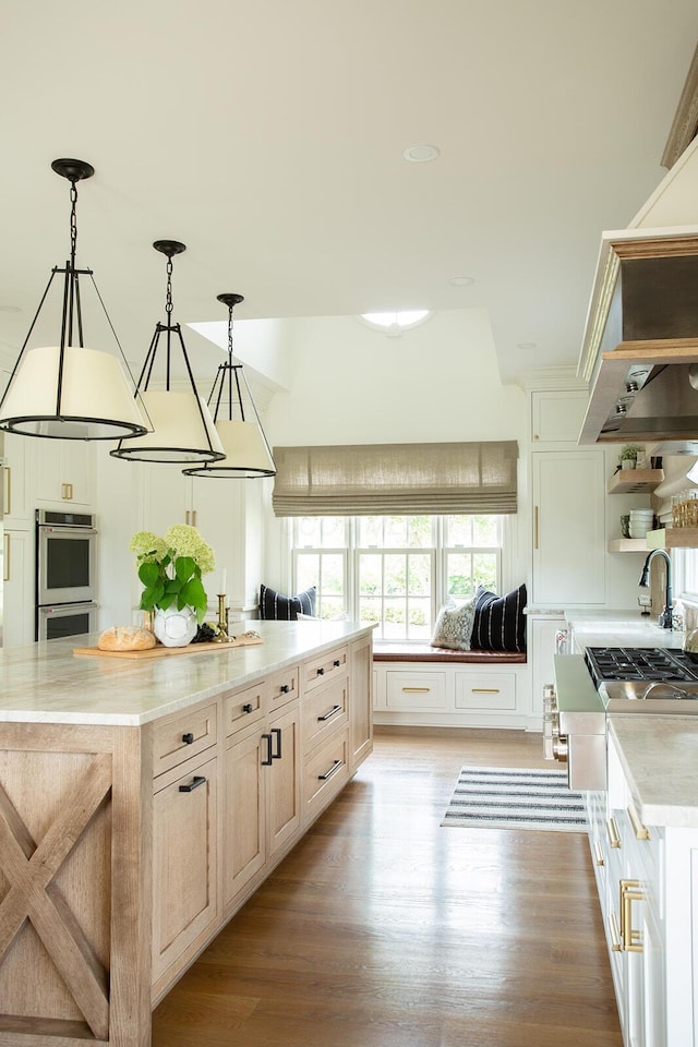 8070 Harriott Rd, Dublin, OH 43017 - kitchen featuring double oven, open shelves, light wood-style flooring, and decorative light fixtures
