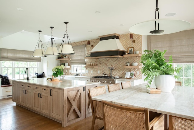 8070 Harriott Rd, Dublin, OH 43017 - kitchen featuring open shelves, custom exhaust hood, a large island, a sink, and wood finished floors