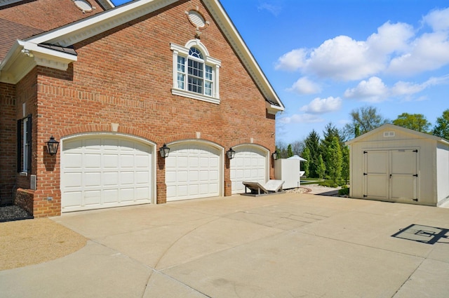 8070 Harriott Rd, Dublin, OH 43017 - view of property exterior featuring a storage unit, brick siding, an attached garage, and driveway