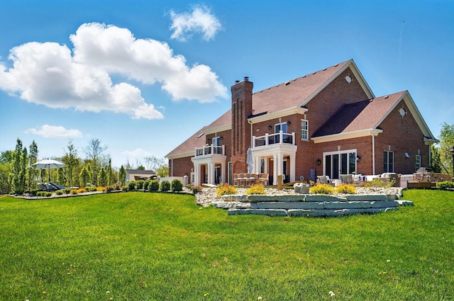 8070 Harriott Rd, Dublin, OH 43017 - back of property with a balcony, a chimney, brick siding, a yard, and an outdoor hangout area