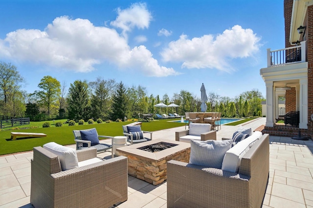 8070 Harriott Rd, Dublin, OH 43017 - view of patio / terrace with an outdoor living space with a fire pit, a pool, a balcony, and view of wooded area