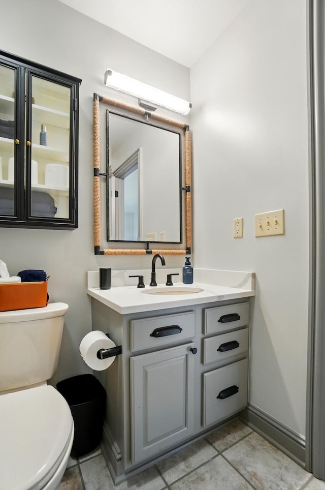 8070 Harriott Rd, Dublin, OH 43017 - half bath featuring toilet, vanity, tile patterned flooring, and baseboards