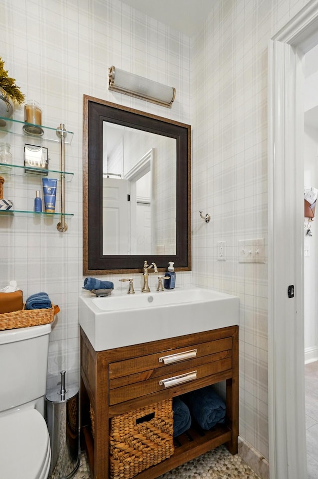 8070 Harriott Rd, Dublin, OH 43017 - half bathroom featuring toilet, vanity, and baseboards