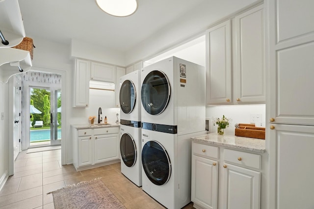 8070 Harriott Rd, Dublin, OH 43017 - laundry room with cabinet space, estacked washer and dryer, washing machine and clothes dryer, and light tile patterned floors