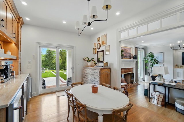8070 Harriott Rd, Dublin, OH 43017 - dining area with beverage cooler, a fireplace, light wood finished floors, recessed lighting, and a chandelier