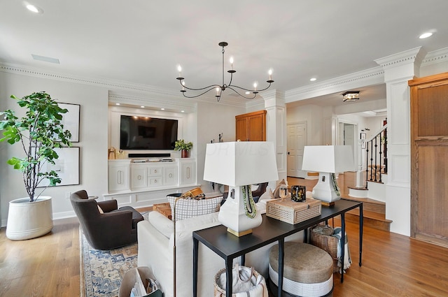 8070 Harriott Rd, Dublin, OH 43017 - living room featuring light wood-style floors, crown molding, stairway, recessed lighting, and a chandelier