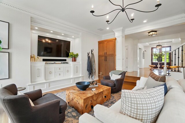 8070 Harriott Rd, Dublin, OH 43017 - living area with light wood-style floors, ornamental molding, ornate columns, a chandelier, and recessed lighting