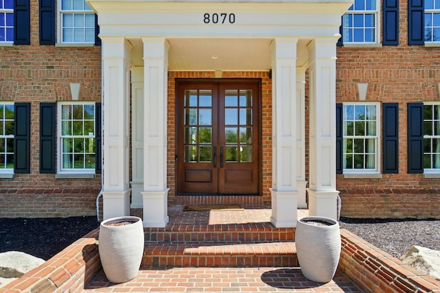 8070 Harriott Rd, Dublin, OH 43017 - entrance to property with french doors, brick siding, and a porch