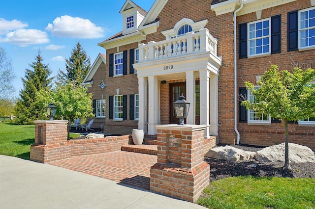 8070 Harriott Rd, Dublin, OH 43017 - property entrance featuring a balcony and brick siding