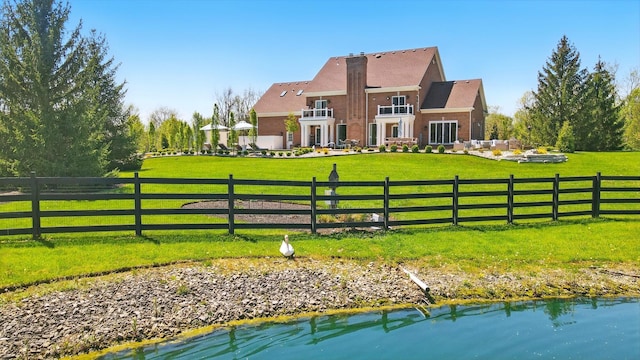 8070 Harriott Rd, Dublin, OH 43017 - back of house featuring a balcony, stucco siding, and a water view