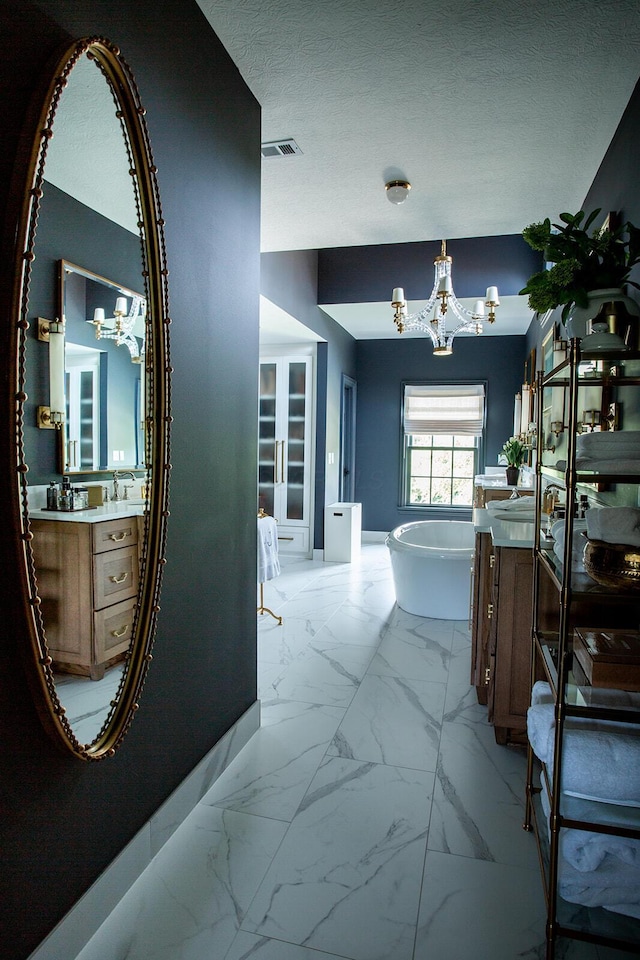 8070 Harriott Rd, Dublin, OH 43017 - hallway with a chandelier and light marble finish flooring