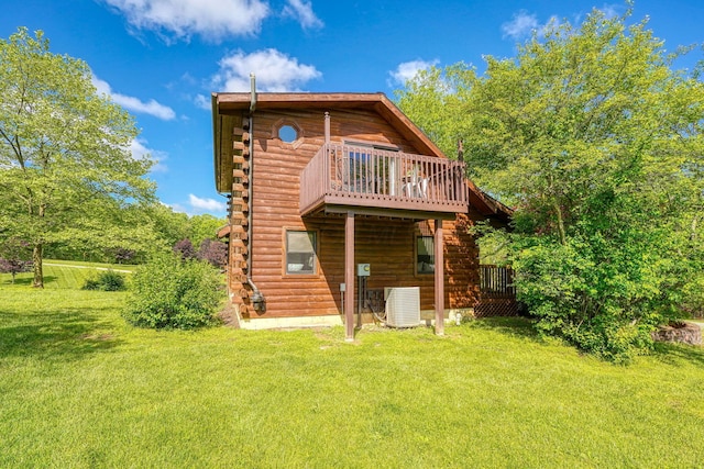 back of house featuring log exterior, a yard, central air condition unit, and a wooden deck