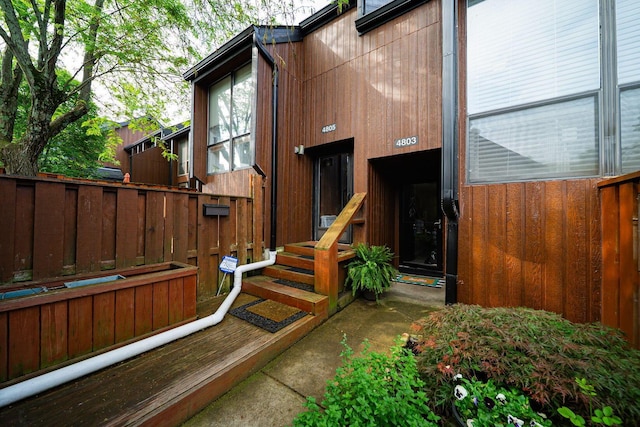 doorway to property featuring fence