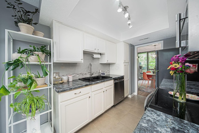 kitchen featuring dishwasher, a sink, light tile patterned floors, white cabinets, and electric range