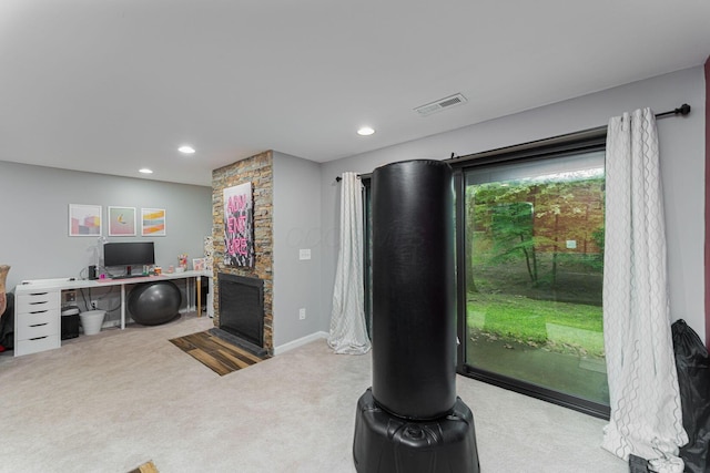 carpeted office featuring recessed lighting, a fireplace, and baseboards