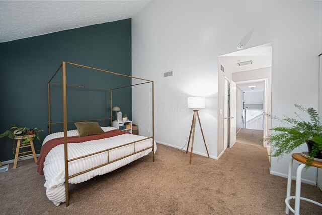 carpeted bedroom featuring baseboards and high vaulted ceiling