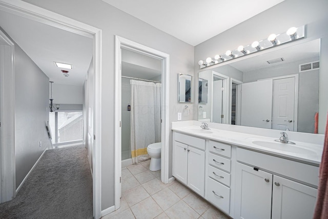 bathroom with toilet, double vanity, baseboards, tile patterned flooring, and a shower with shower curtain
