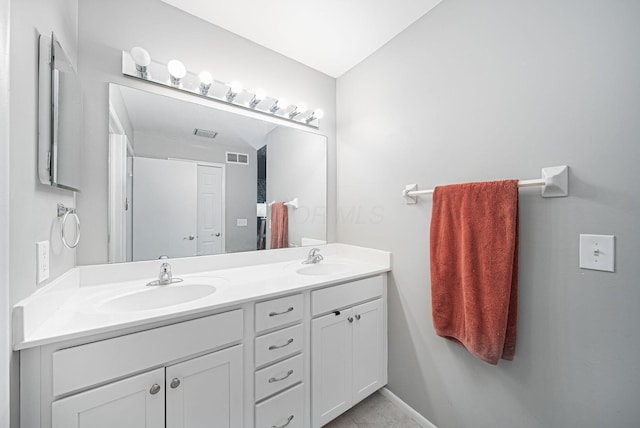 full bath featuring double vanity and tile patterned floors
