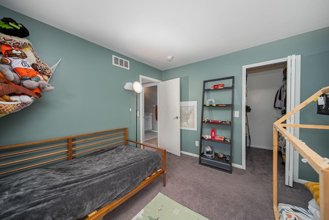 carpeted bedroom featuring baseboards and a spacious closet