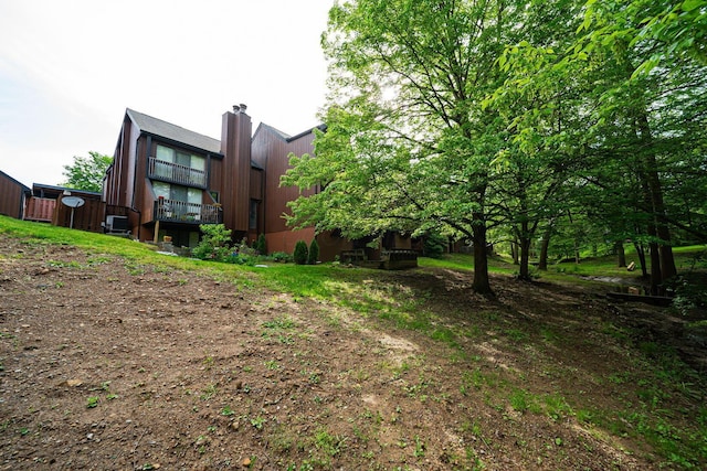 back of house with a chimney