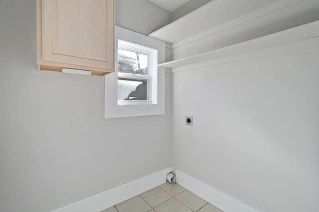 411 Reinhard Ave, Columbus, OH 43206 - laundry room with electric dryer hookup, cabinet space, light tile patterned flooring, and baseboards