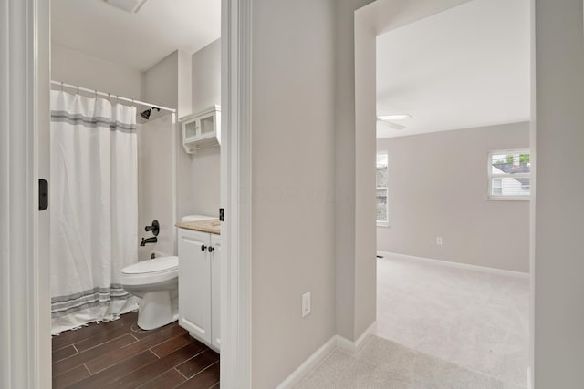 411 Reinhard Ave, Columbus, OH 43206 - bathroom featuring baseboards, a shower with shower curtain, vanity, and toilet