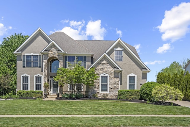 2557 Coltsbridge Dr, Lewis Center, OH 43035 - view of front facade with stone siding, a front yard, and stucco siding