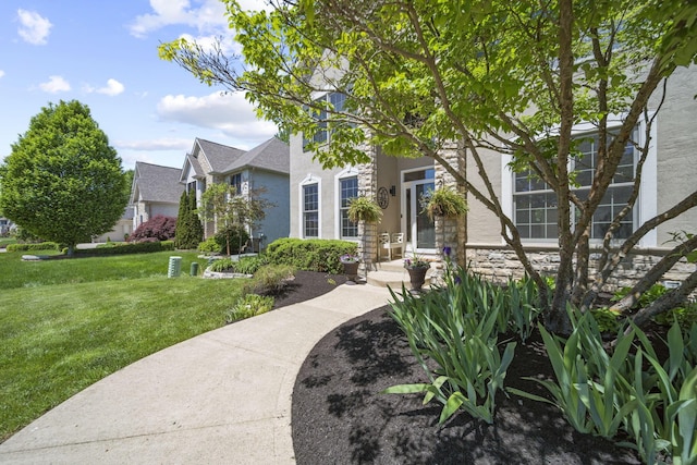 2557 Coltsbridge Dr, Lewis Center, OH 43035 - view of front of property featuring stucco siding, a front lawn, and stone siding