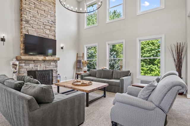 2557 Coltsbridge Dr, Lewis Center, OH 43035 - living room featuring light colored carpet, a towering ceiling, plenty of natural light, a chandelier, and a fireplace
