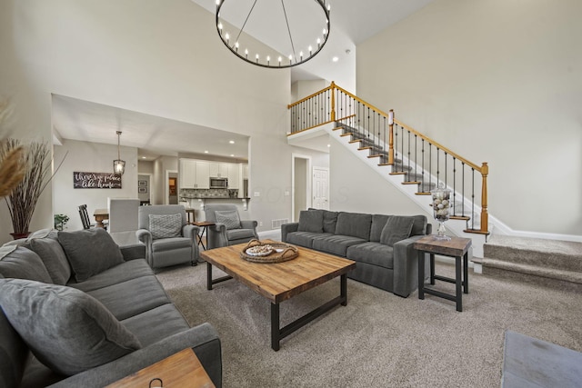 2557 Coltsbridge Dr, Lewis Center, OH 43035 - living room with stairway, light carpet, a towering ceiling, a chandelier, and baseboards
