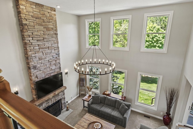 2557 Coltsbridge Dr, Lewis Center, OH 43035 - living area with a stone fireplace, plenty of natural light, baseboards, and a high ceiling