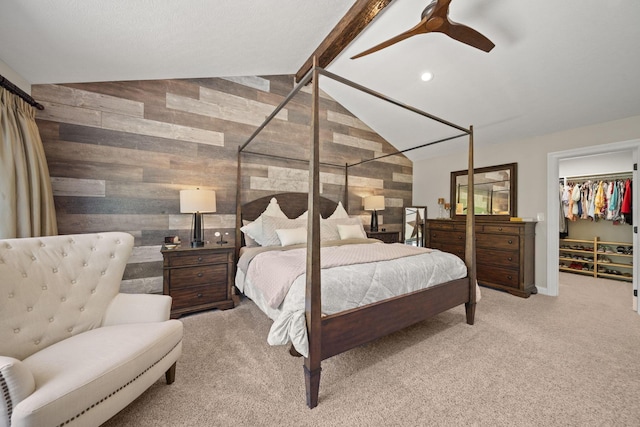2557 Coltsbridge Dr, Lewis Center, OH 43035 - carpeted bedroom with wooden walls, a walk in closet, a ceiling fan, and a closet