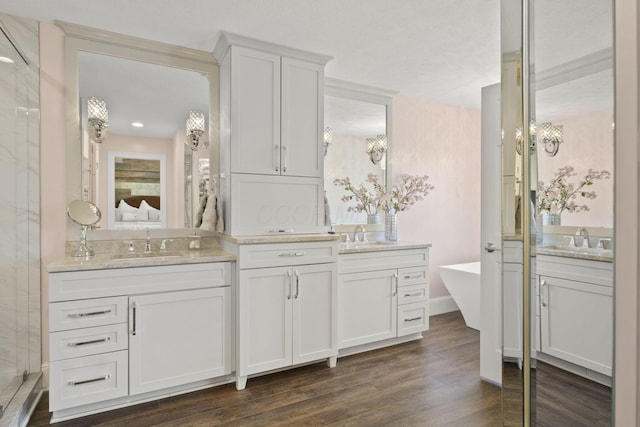 2557 Coltsbridge Dr, Lewis Center, OH 43035 - ensuite bathroom with wood finished floors, two vanities, a freestanding bath, a shower, and recessed lighting