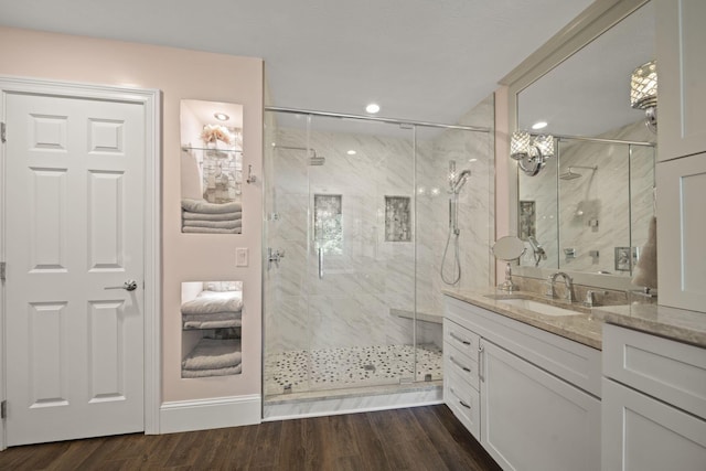 2557 Coltsbridge Dr, Lewis Center, OH 43035 - bathroom featuring vanity, a marble finish shower, wood finished floors, baseboards, and recessed lighting