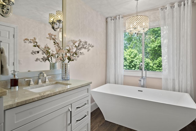 2557 Coltsbridge Dr, Lewis Center, OH 43035 - full bathroom featuring a chandelier, healthy amount of natural light, vanity, and a freestanding bath