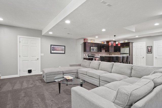 2557 Coltsbridge Dr, Lewis Center, OH 43035 - living area featuring recessed lighting, dark colored carpet, and baseboards