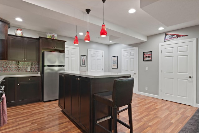 2557 Coltsbridge Dr, Lewis Center, OH 43035 - kitchen with freestanding refrigerator, light wood-type flooring, light countertops, recessed lighting, and backsplash