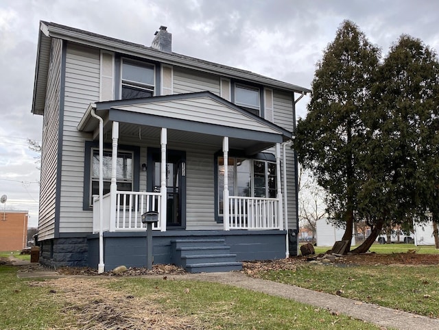 view of front of property with covered porch and a chimney