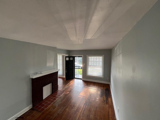 155 Schultz Ave, Columbus, OH 43222 - unfurnished living room featuring dark wood-type flooring, baseboards, and a fireplace