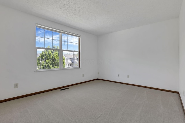 3625 Parker Knoll Ln, Columbus, OH 43219 - spare room featuring carpet floors, baseboards, and a textured ceiling