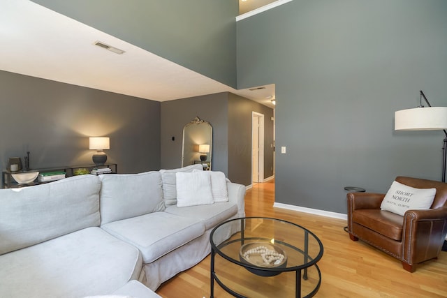 living room featuring light wood-style flooring and baseboards