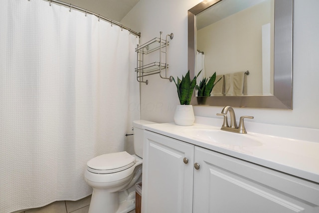 full bath with toilet, vanity, and tile patterned flooring