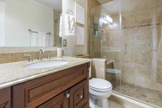full bath featuring a shower stall, vanity, toilet, and tile patterned flooring