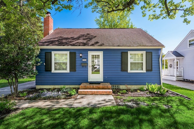263 E Beaumont Rd, Columbus, OH 43214 - view of front of house with a chimney, a front yard, and roof with shingles