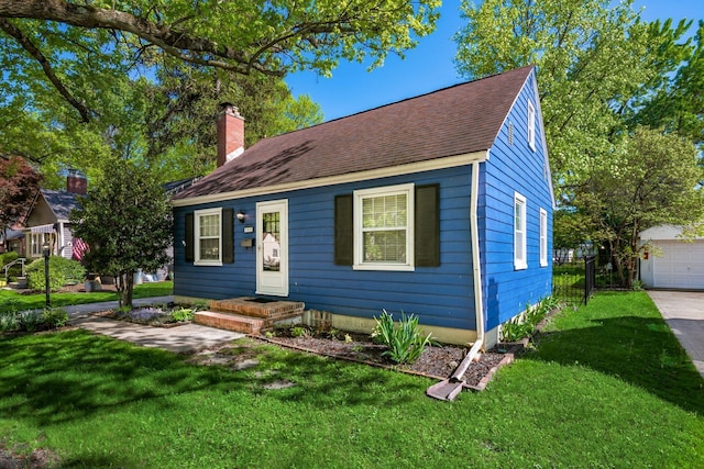 263 E Beaumont Rd, Columbus, OH 43214 - view of front of house with a chimney, a shingled roof, and an outbuilding