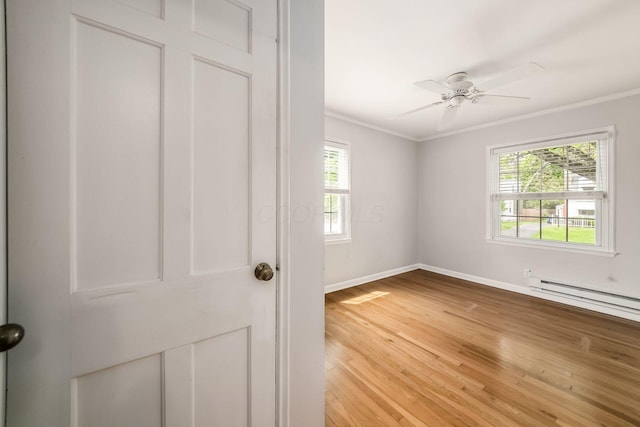 263 E Beaumont Rd, Columbus, OH 43214 - spare room with ornamental molding, light wood-style flooring, baseboards, a ceiling fan, and a baseboard radiator