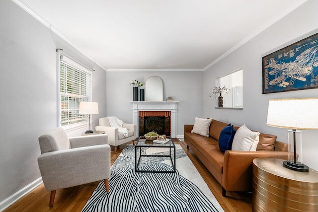 263 E Beaumont Rd, Columbus, OH 43214 - living room with wood finished floors, crown molding, a brick fireplace, and baseboards