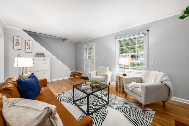 263 E Beaumont Rd, Columbus, OH 43214 - living room with ornamental molding, stairs, light wood finished floors, baseboards, and arched walkways